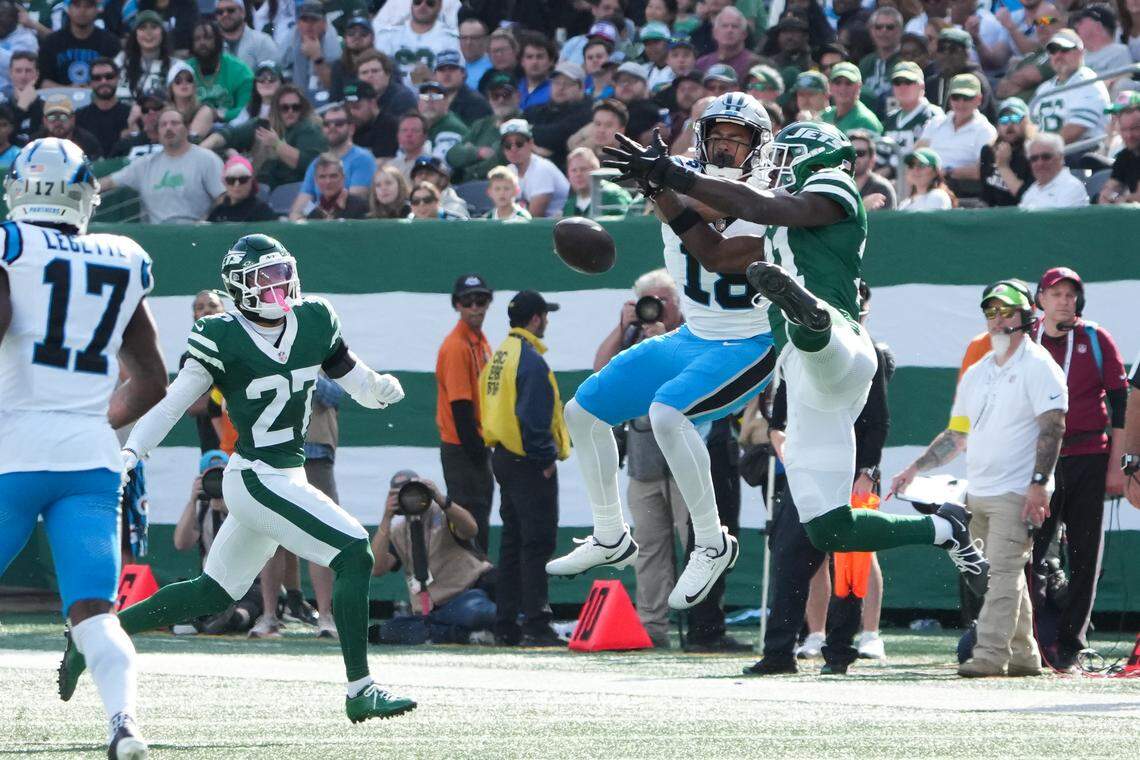 Carolina Panthers wide receiver Jalen Coker (18) and New York Jets cornerback Brandon Stephens (21) battle for the ball in the second quarter on Sunday in New Jersey.