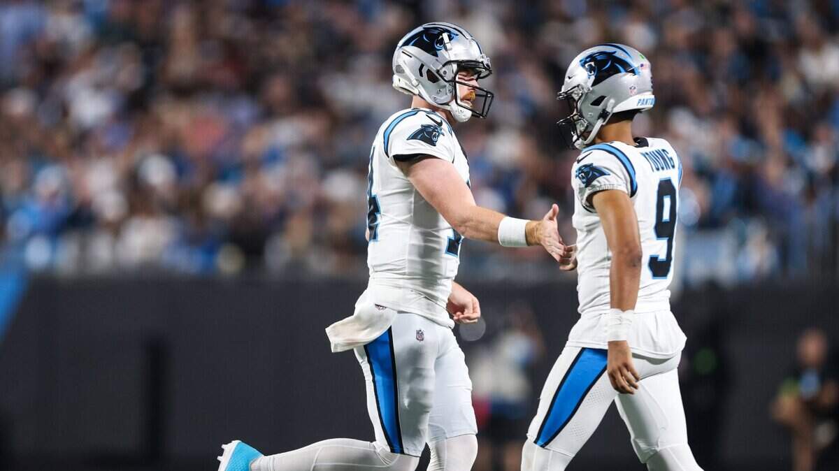 Carolina Panthers quarterback Bryce Young, right gives Andy Dalton a low five as they trade positions on the field at the Bank of America Stadium in Charlotte, N.C., on Monday, September 18, 2023.