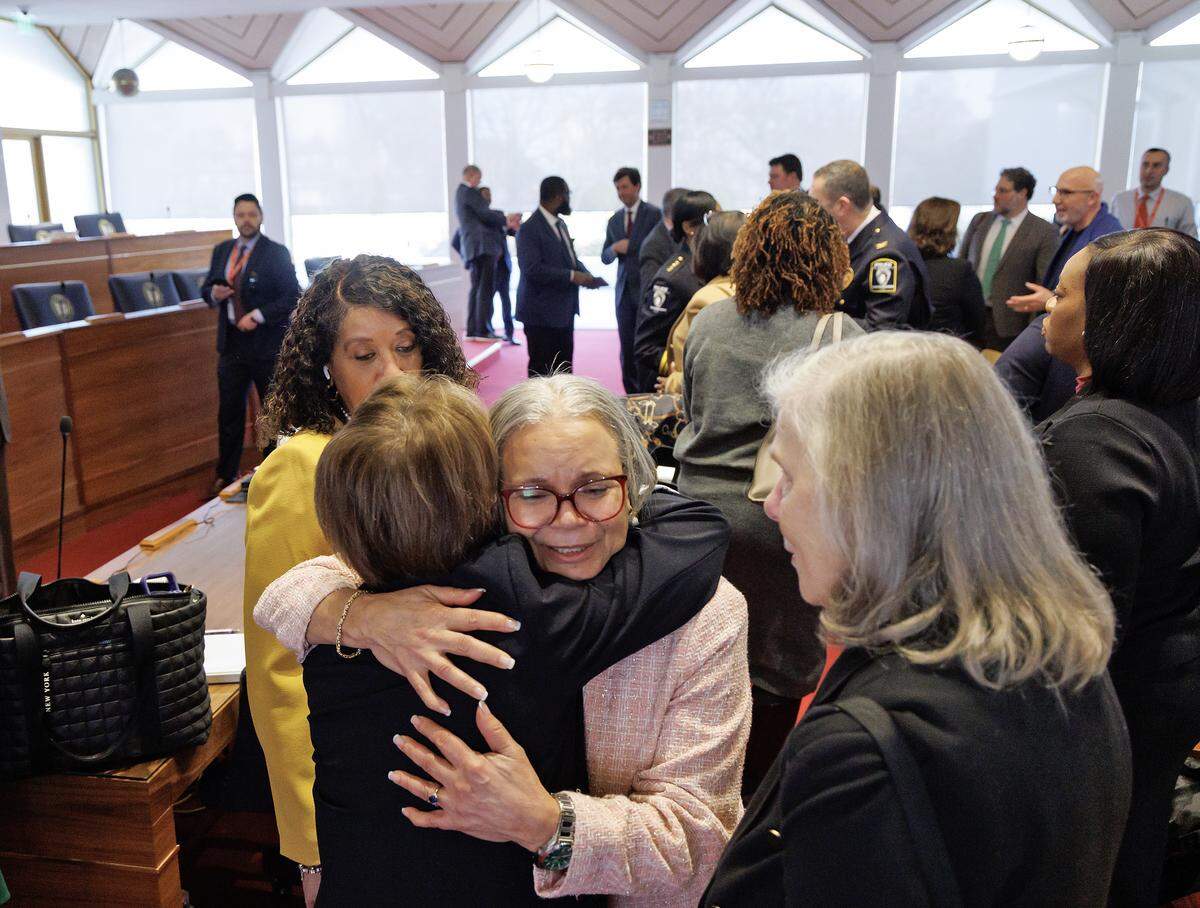 Charlotte Mayor Vi Lyles, center, receives a hug following the conclusion of the House Select Committee on Oversight and Reform on Monday, Feb. 9, 2026, at the North Carolina Legislative Building. 