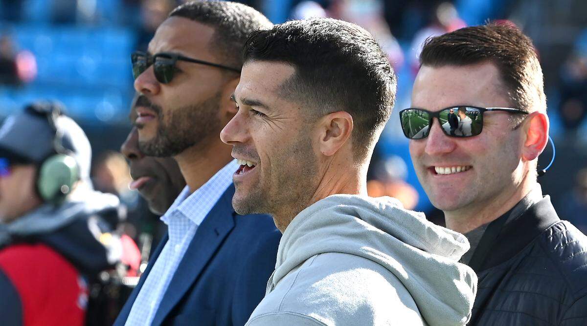 Tampa Bay Buccaneers offensive coordinator Dave Canales, center, stands along the Carolina Panthers sideline prior to the team’s game at Bank of America Stadium on Sunday, January 7, 2024 in Charlotte, NC. The Buccaneers defeated the Panthers 9-0.