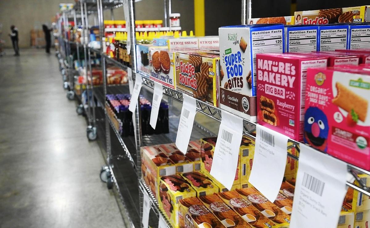 Workers tag grocery items on the shelves at the Farmstead Charlotte’ offices on Thursday, November 19, 2020. This is a new expansion of the online grocer into the Charlotte area.