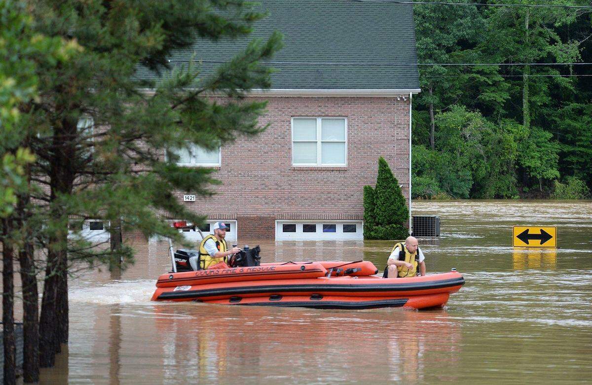 A 2019 Charlotte Observer file photo shows residents of Riverside Drive evacuating due to major flooding in their neighborhood that June.