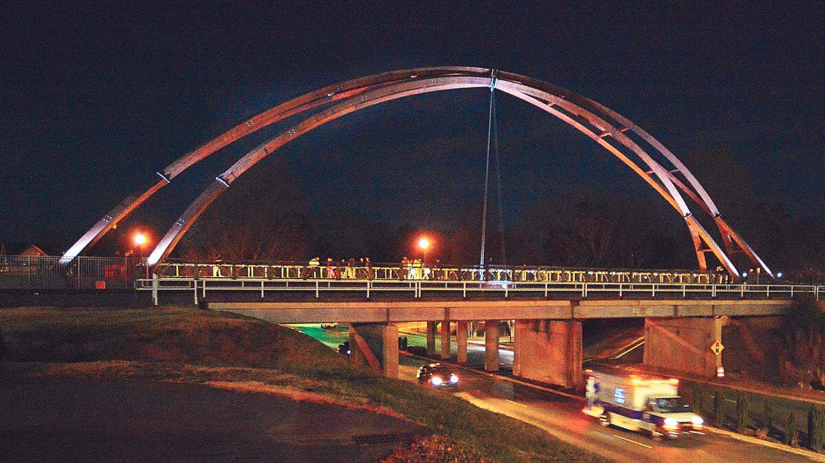 Traffic flows under the lighted arches over N.C. 127, after the dedication of the Rudy Wright bridge in Hickory, NC. The arches are an artistic component of a pedestrian bridge named for the former Hickory mayor, which itself is part of the City Walk. They collapsed on Friday Feb. 18, 2022.
