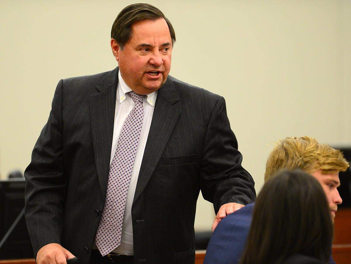 Defense attorney George Laughrun, left, speaks to the jury about his client Kevin Olsen, right, during his closing argument on Monday.