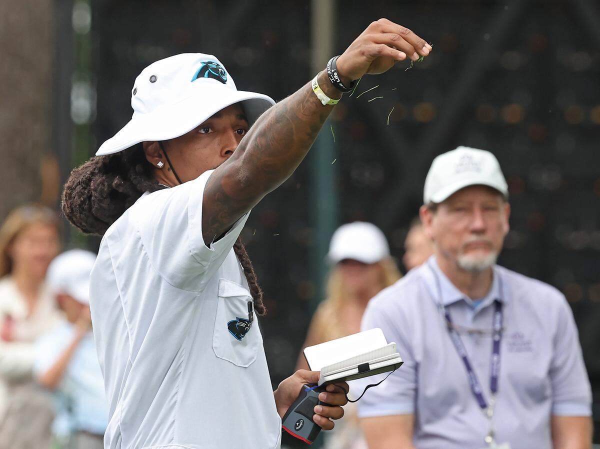 Former Carolina Panthers safety Tre Boston check the strength of the wind at the first tee box before former fullback Mike Tolbert hits during the Truist Championship Pro-Am at Quail Hollow Club in Charlotte, NC on Wednesday, May 6, 2026. 