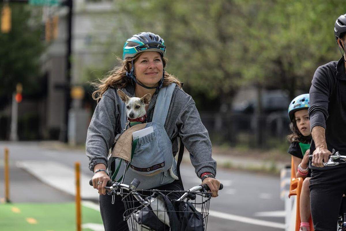 Families and their pets were among those trying out the new bicycle lanes along Fifth and Sixth streets in uptown Charlotte on April 16, 2022.