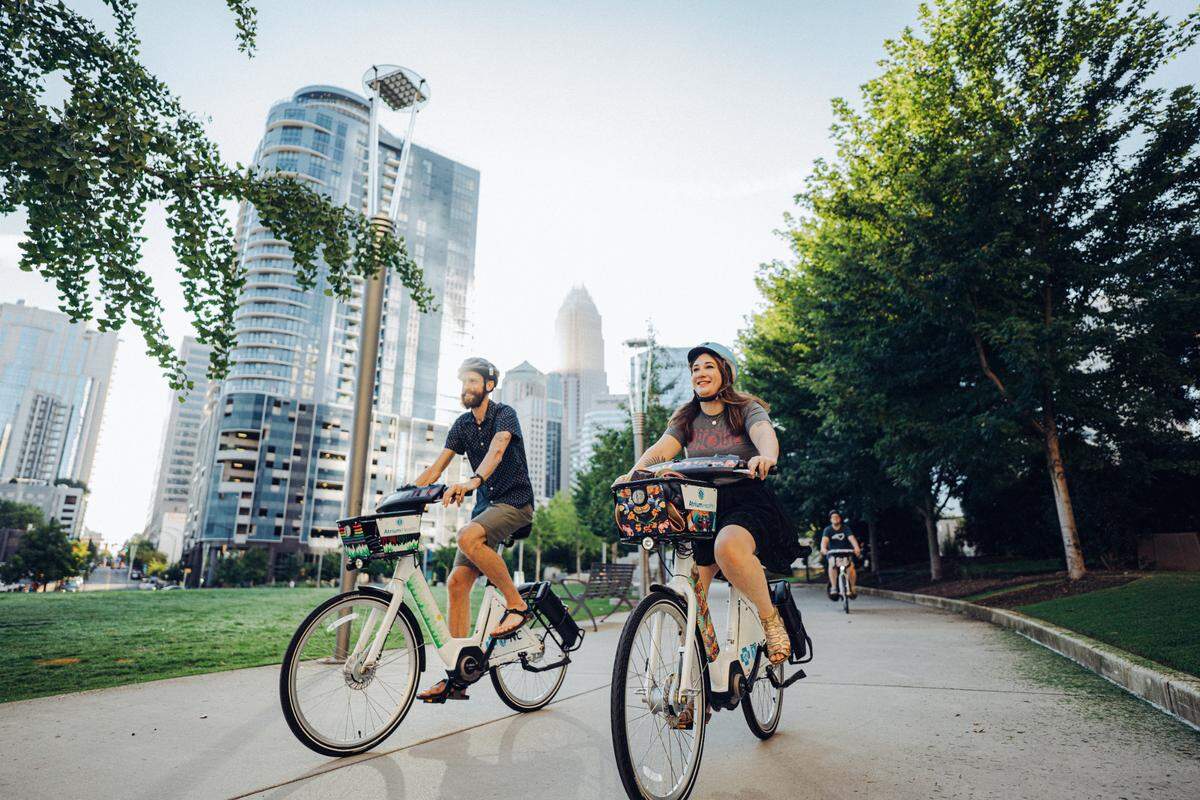 Charlotte Joy Rides pricing is $5 for a 30-minute Flash Pass, or $30 for 24-hour Joy Pass, with monthly and yearly options available. A bike lock is included.
