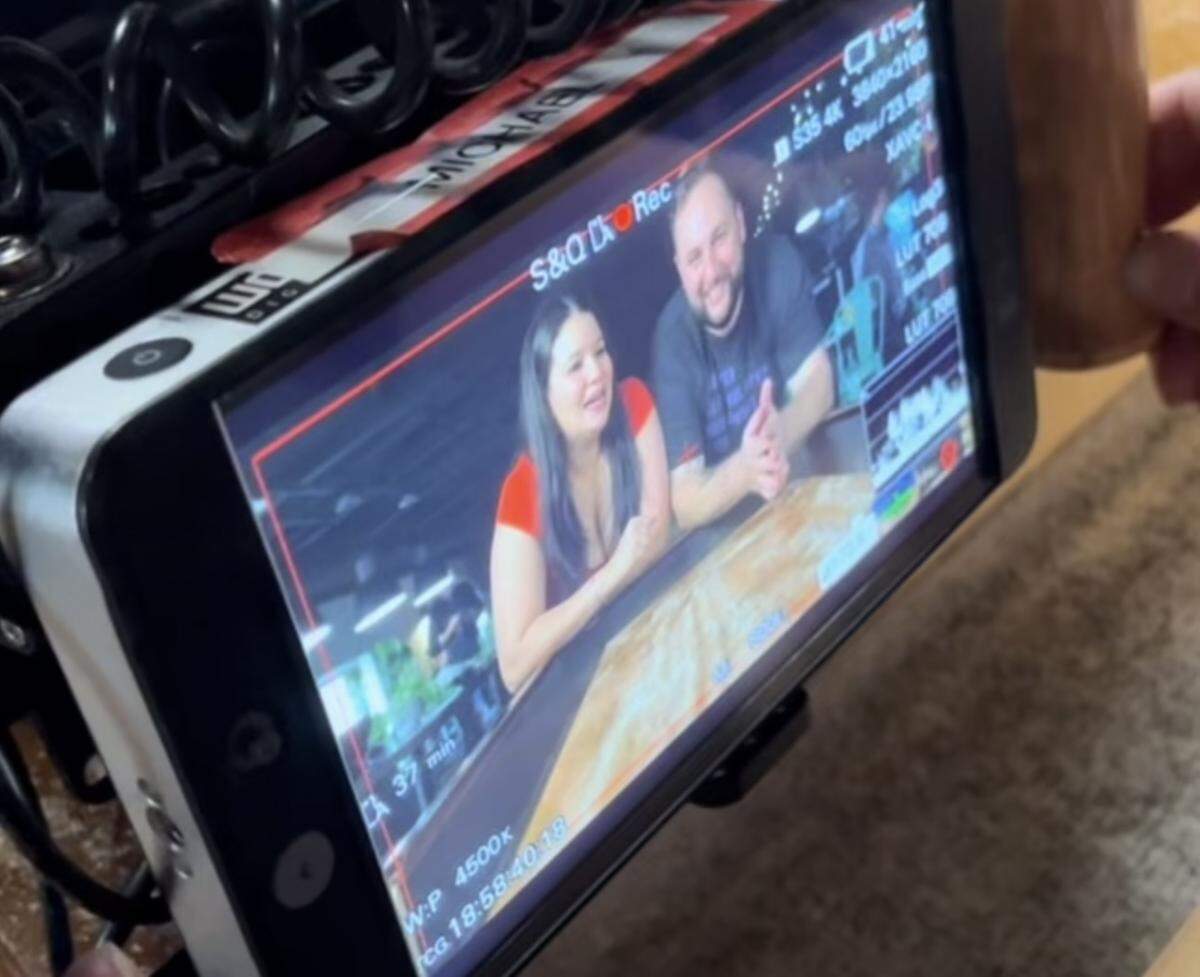 Salud owners Dairelyn and Jason Glunt are shown through camera equipment during the filming of “Que Delicia: El Sabor De America.”