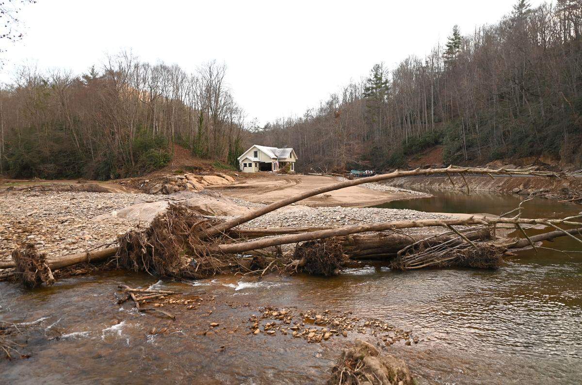 The heavy floodwaters of Hurricane Helene created an extended river bed by a home that sustained heavy damage near Pensacola, N.C., in September.