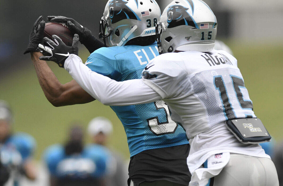 Carolina Panthers cornerback Javien Elliott (38) intercepts a pass Monday intended for wide receiver Chris Hogan (15) during training camp at Wofford College.