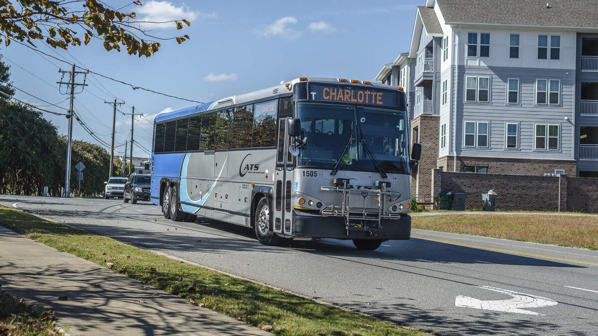 A CATS express bus travels a Charlotte street.