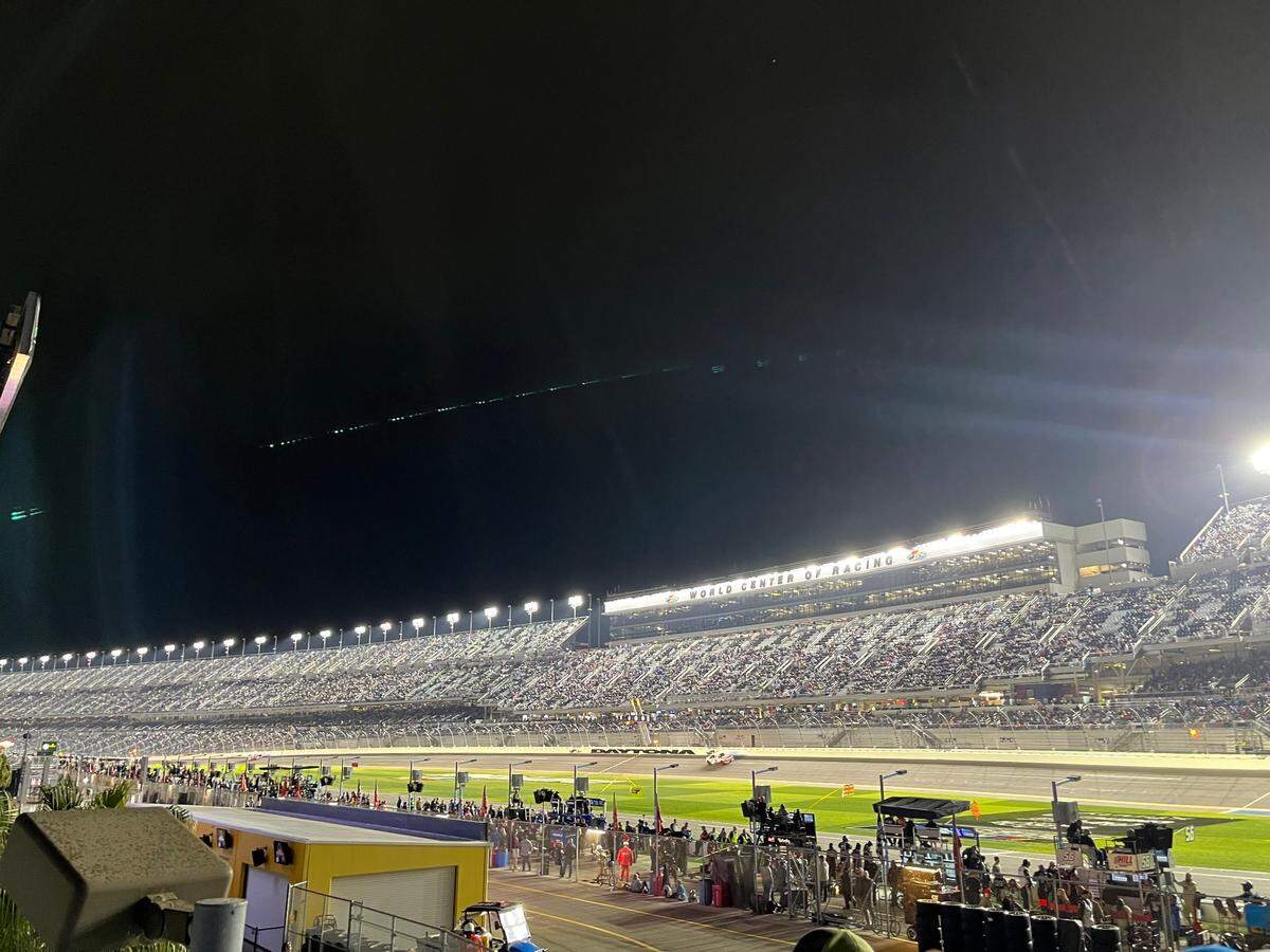 Trucks drive around the track under caution while Friday’s NASCAR Craftsman Truck Series race at Daytona was briefly stopped because of light rain.