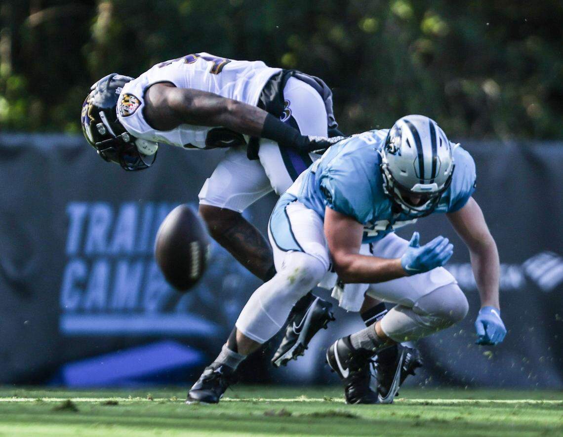 Carolina Panthers tight end Dan Arnold, right, can’t come up with a catch in front of Baltimore Ravens safety Chuck Clark during the two teams’ joint practice in Spartanburg, S.C., on Wednesday.