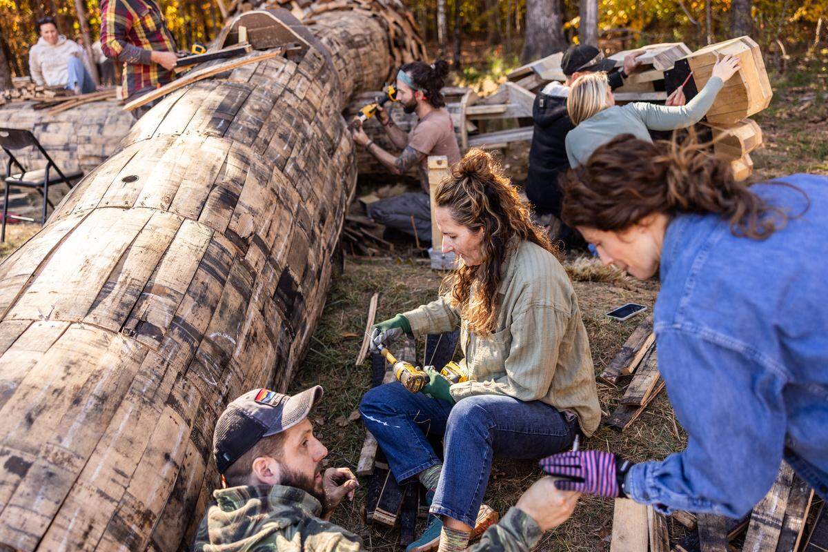 Volunteers work on constructing a giant troll sculpture named Pete with the Big Feet by Danish artist Thomas Dambo in Charlotte, N.C., on Thursday, November 6, 2025.