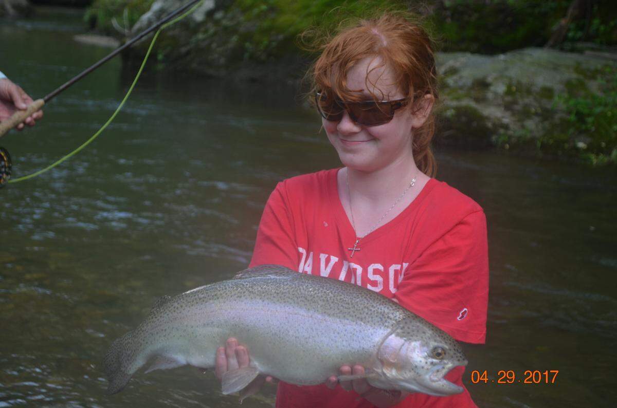 Myree Kromer hoists the rainbow trout she caught while fly fishing during a family trip with her brothers’ Boy Scout troop in 2017.