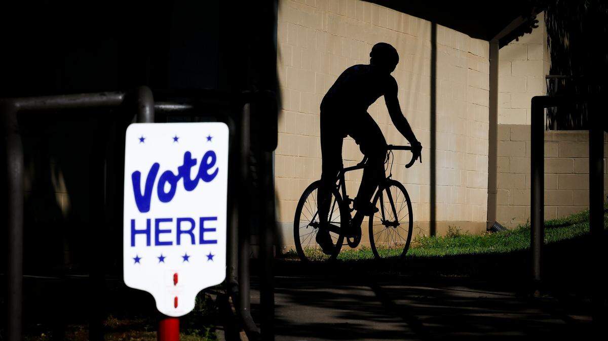 Brian Conroy, of Charlotte, N.C., heads out for his evening ride after voting at the Hawthorne Recreation Center in Charlotte, May 17, 2022.