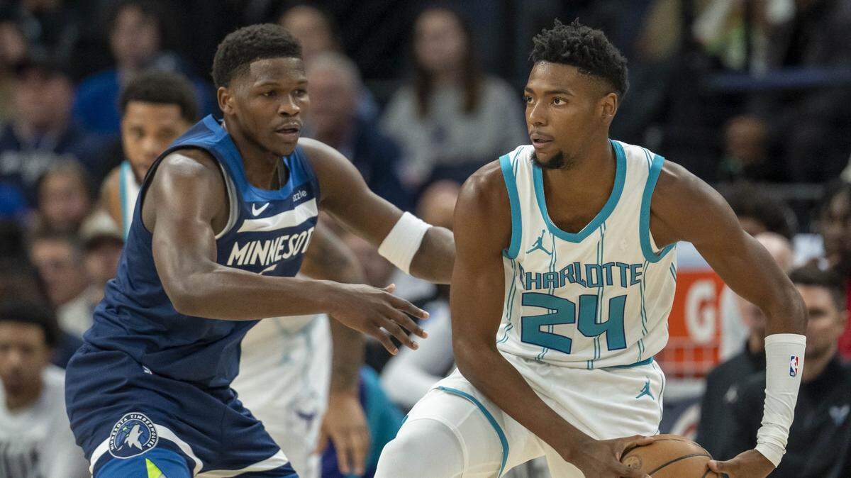 Charlotte Hornets forward Brandon Miller (24) looks to pass the ball past Minnesota Timberwolves guard Anthony Edwards (5) in the first half at Target Center.