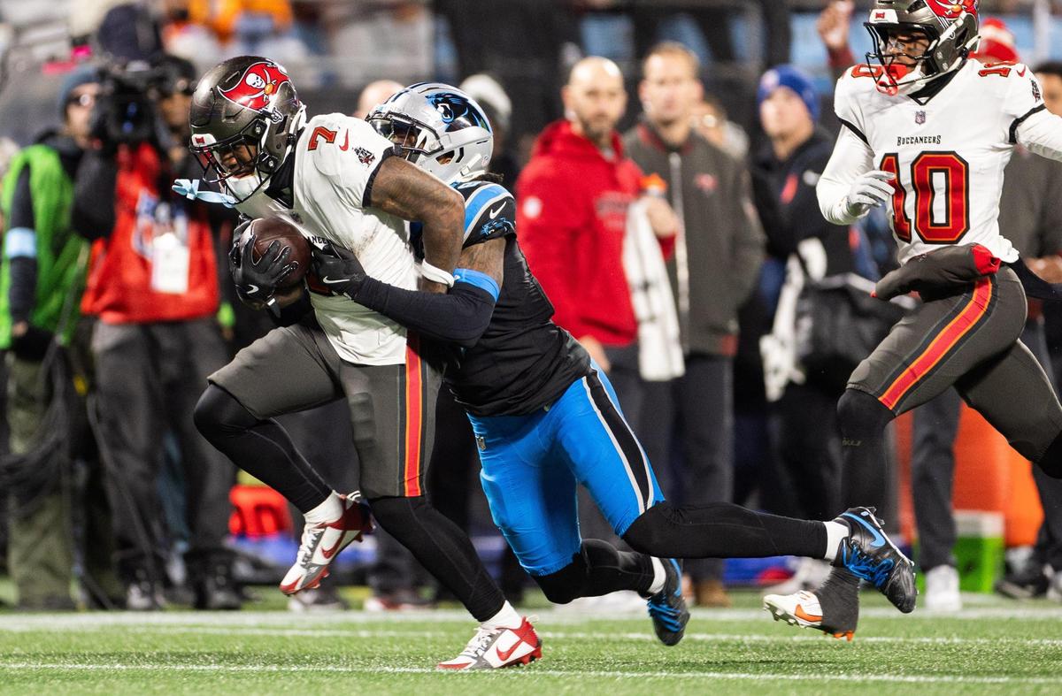 Tampa Bay Buccaneers running back Bucky Irving, left, is tackled by Carolina Panthers cornerback Jaycee Horn at the Bank of America Stadium in Charlotte, N.C., on Sunday, December 1, 2024.