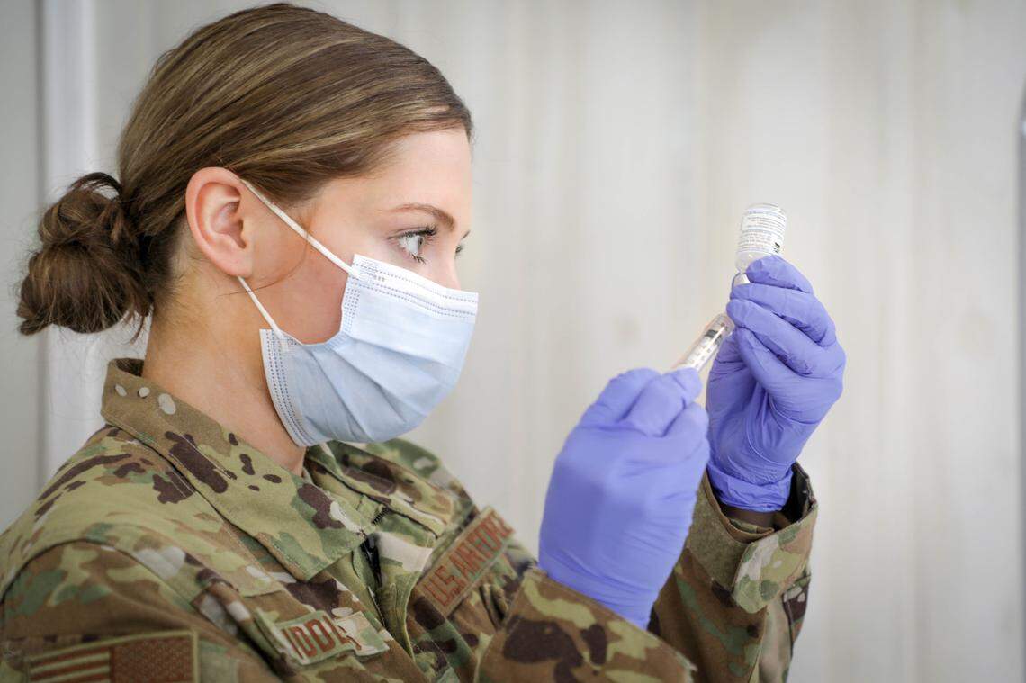 North Carolina National Guard Airman First Class Emily Riddles prepares a COVID-19 vaccine shot at Central Prison in Raleigh.
