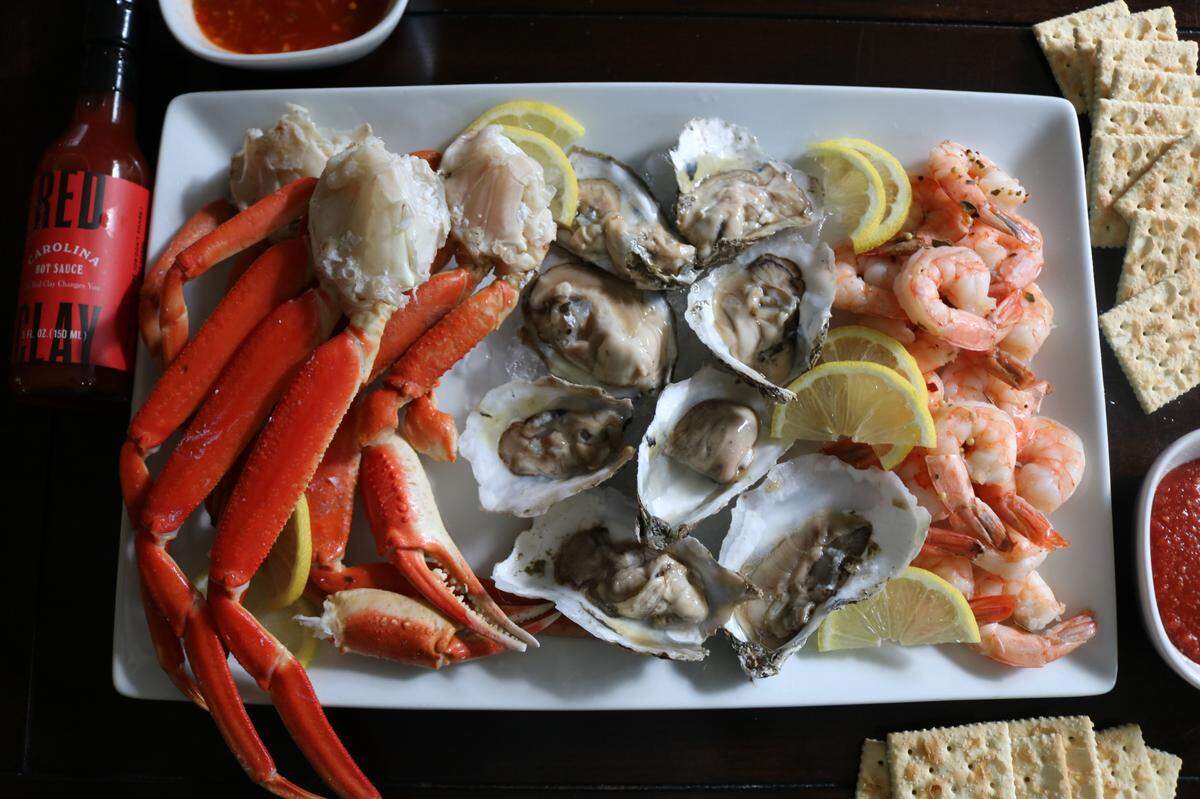 The Dockside package comes with poached jumbo shrimp, snow crab claws, ½ shell oysters, salted lavash crackers, local hot sauce, house made apricot mignonette, spicy cocktail sauce and fresh lemons, starting at $155.