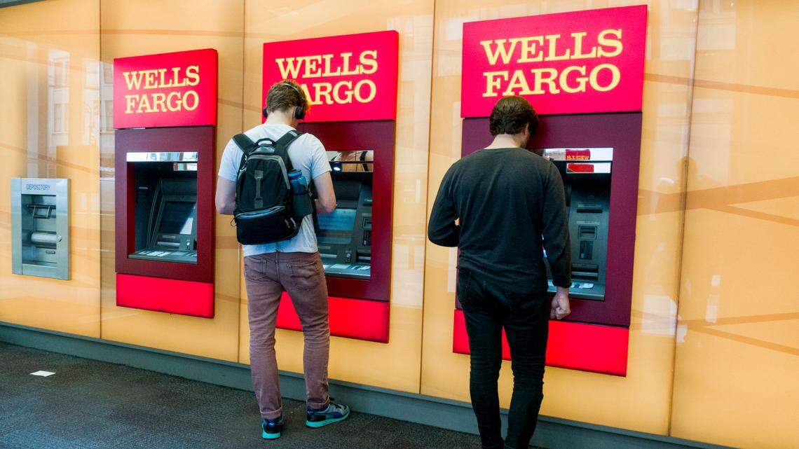 FILE — Patrons use ATMs at a Wells Fargo bank in New York, Sept. 7, 2017. Wells Fargo agreed to pay $575 million to resolve investigations by all 50 states and Washington, D.C., that began after federal regulators revealed in September 2016 that employees had for years opened millions of unauthorized bank accounts in customers’ names. (Devin Yalkin/The New York Times)