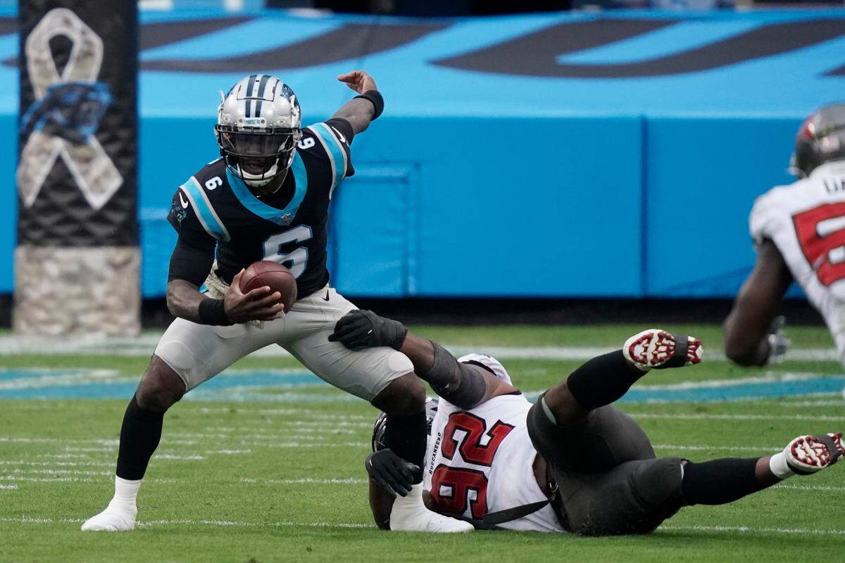 Carolina Panthers quarterback P.J. Walker (6) worlks as Tampa Bay Buccaneers defensive end William Gholston (92) defends during the second half of an NFL football game, Sunday, Nov. 15, 2020, in Charlotte , N.C. (AP Photo/Gerry Broome)