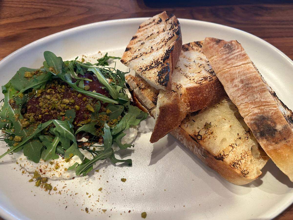 North Italia’s Burrata di Stagione is topped with red wine-poached pear, Sicilian pistachio crumble and affinato, served with grilled ciabatta for dipping.