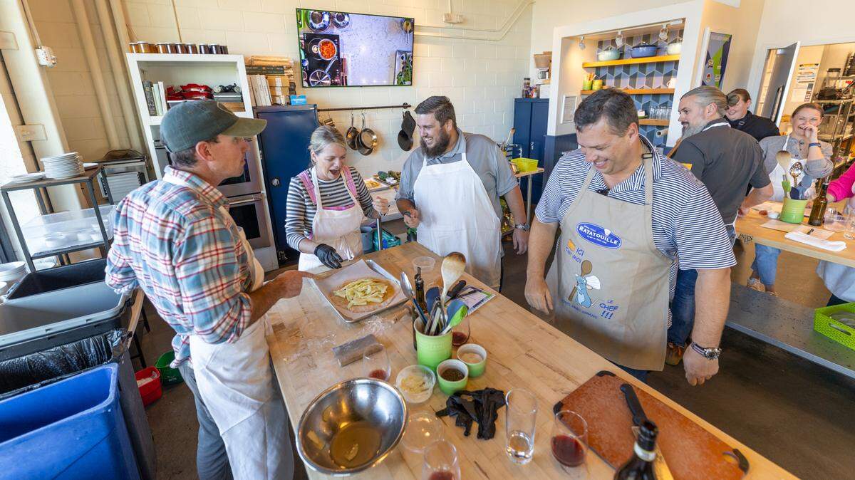Chef Alyssa’s Kitchen offers an array culinary classes. Here, folks are learning how to skin and slice an apple to make a dessert.