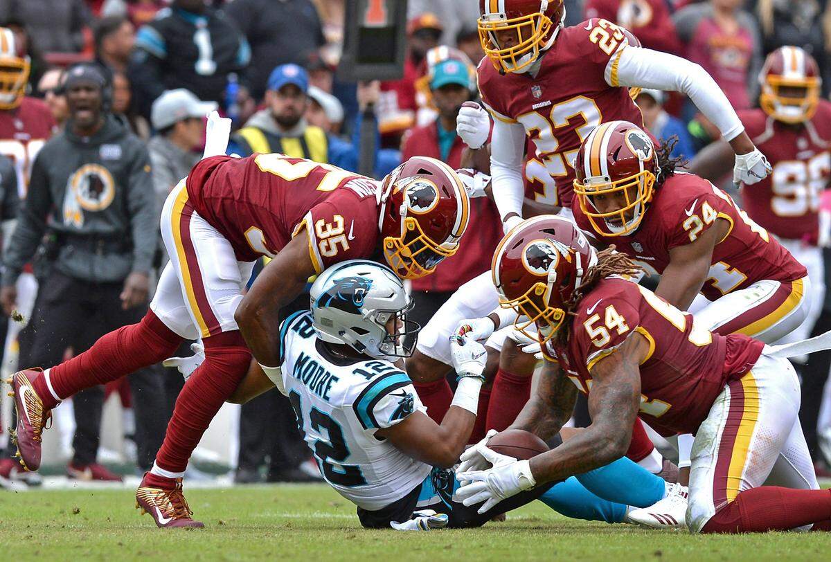 Washington Redskins linebacker Mason Foster, right, recovers a fumble by Carolina Panthers wide receiver DJ Moore during first half action at FedEx Field in Landover, Maryland on Sunday, October 14, 2018. The ball was punched out by former Panthers cornerback Josh Norman (No. 24).