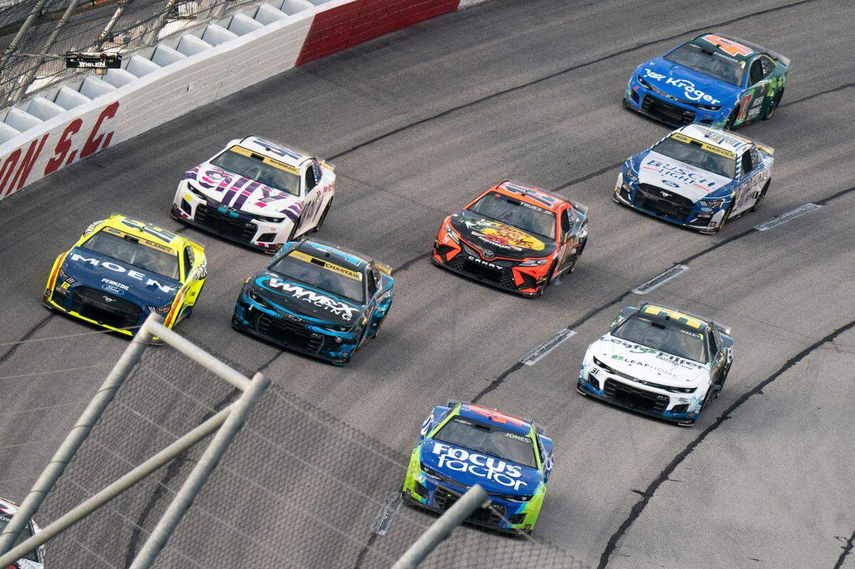Erik Jones (43), Ross Chastain (1), Ryan Blaney (12), Alex Bowman (48), Martin Truex (19), Kevin Harvick (4) and Ricky Stenhouse Jr. (47) compete in the NASCAR Southern 500 auto race Sunday, Sept. 4, 2022, in Darlington, S.C. Jones won the race after taking the lead from Kyle Busch when Busch blew a motor with 30 laps remaining in the race. (AP Photo/Sean Rayford)
