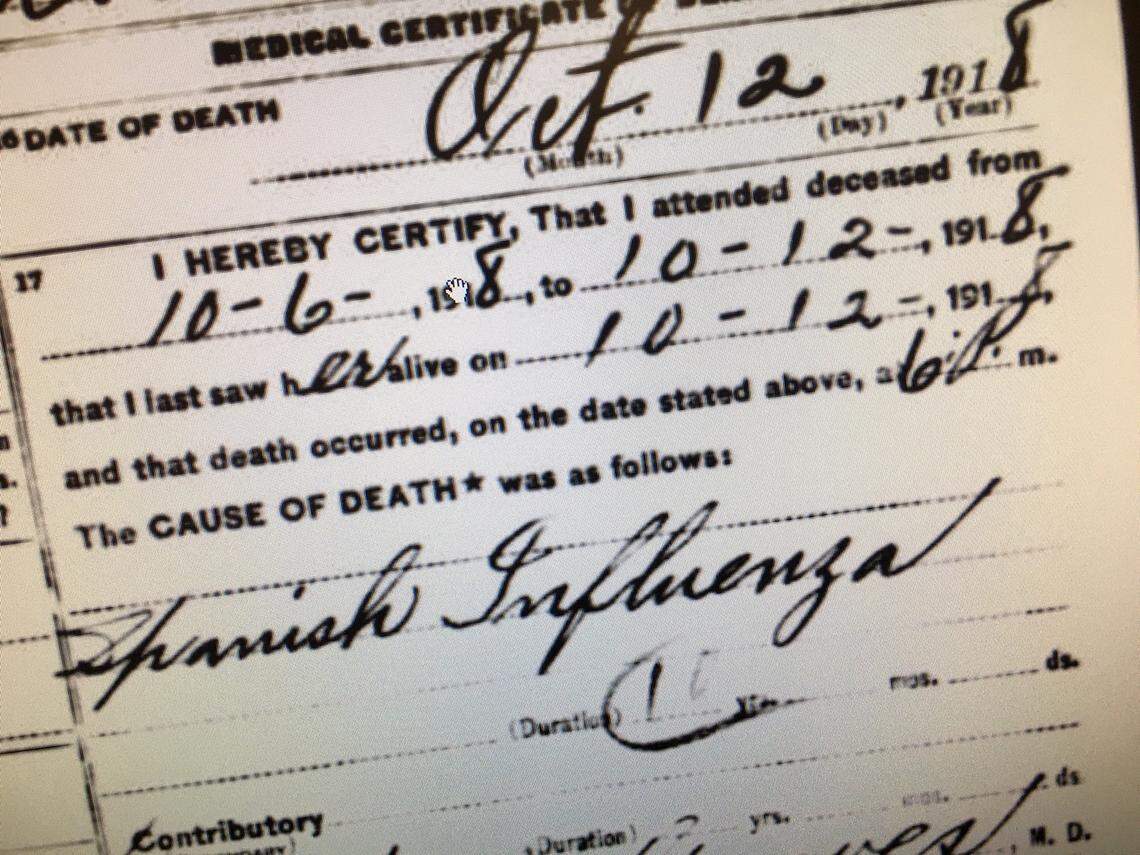 Handwritten death certificates from 1918 cite influenza and pneumonia from the epidemic.