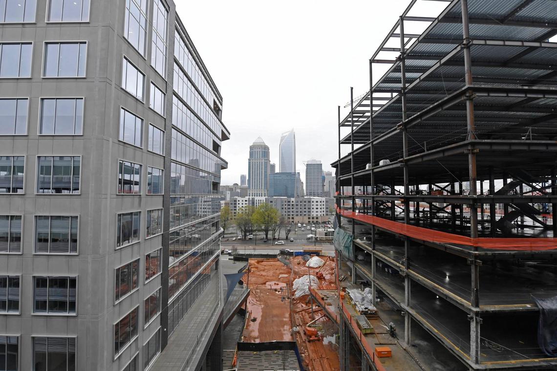 Construction continues on the east office tower, right, at the The Spectrum CompaniesÕ mixed-use Vantage South End project on Friday, March 26, 2021. The project includes two 11-story office towers, retail, a one-acre courtyard and plans for a hotel. LendingTree is preparing for occupancy of the completed west tower, The east office tower is set for completion in early 2022.