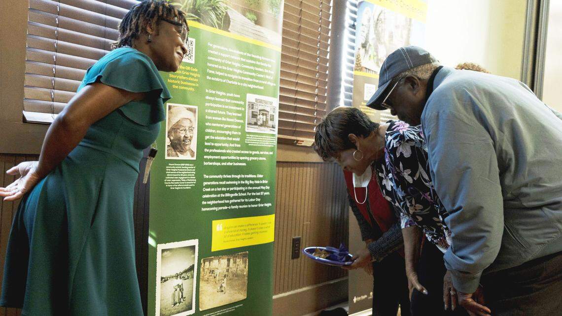 Karen Sutton, left, the Levine’s director of community engagement, with members of the community at the opening reception for the museum’s exhibit on Grier Heights.