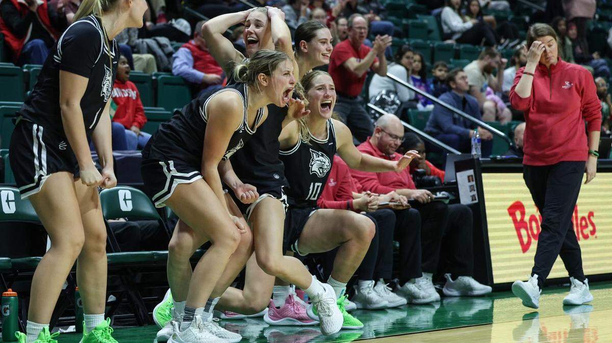 Players on Davidson’s bench celebrate a three-point shot during the game against UNC-Charlotte at Halton Arena on Thursday, December 21, 2023. Davidson’s victory is their ninth win in a row and the best start to a season in the program’s history.