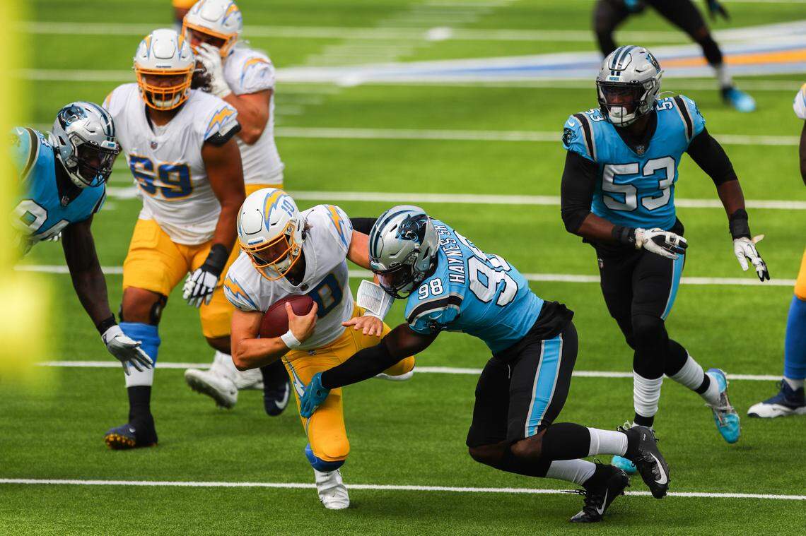 Carolina Panthers defensive end Marquis Haynes (98) sacks Los Angeles Chargers quarterback Justin Herbert (10) on third down during the first quarter of the NFL football game Sunday, Sept. 27, 2020, in Inglewood, Calif.