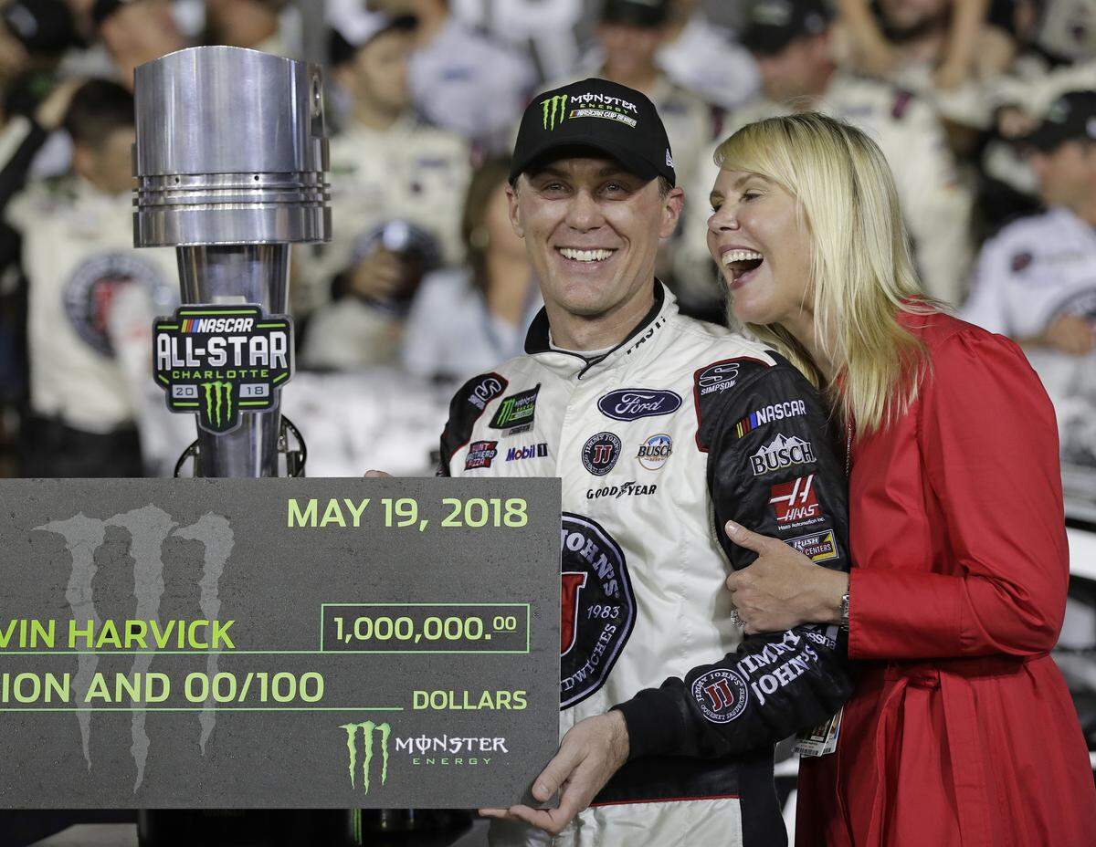 Kevin Harvick celebrates in Victory Lane with his wife, DeLana, after winning the NASCAR All-Star auto race at Charlotte Motor Speedway in Concord on Saturday.