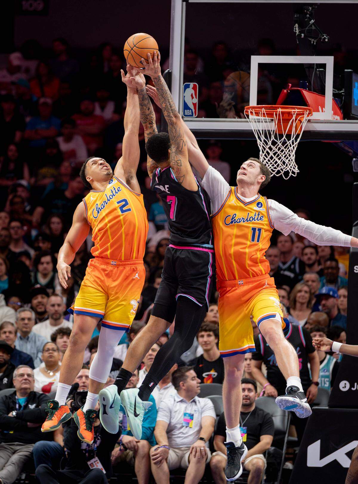 Charlotte Hornet's Grant Williams (2) and Ryan Kalkbrenner (11) defend Kel'el Ware (7) drive to the basket. The Charlotte Hornet's would host the Miami Heat Friday March 6, 2026.