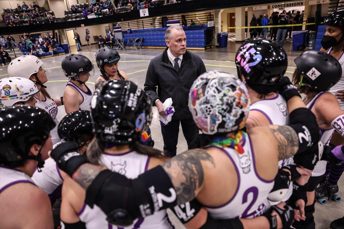 Charlotte Roller Derby huddles before their game against Collision in Charlotte, N.C., on Saturday, March 11, 2023.