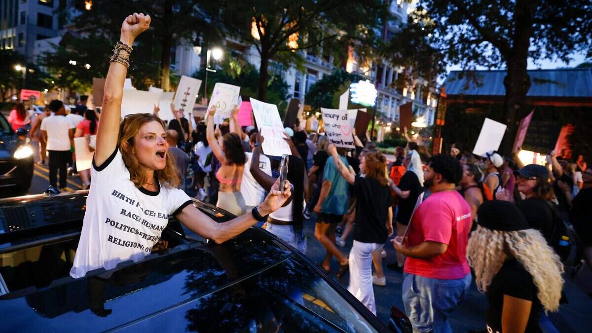 Lisa Landrum, of Charlotte, N.C., shows solidarity with abortion rights activists as they march through uptown Charlotte, Sunday, June 26, 2022. The demonstration was in response to last week’s decision from the U.S. Supreme Court to overturn Roe v. Wade.