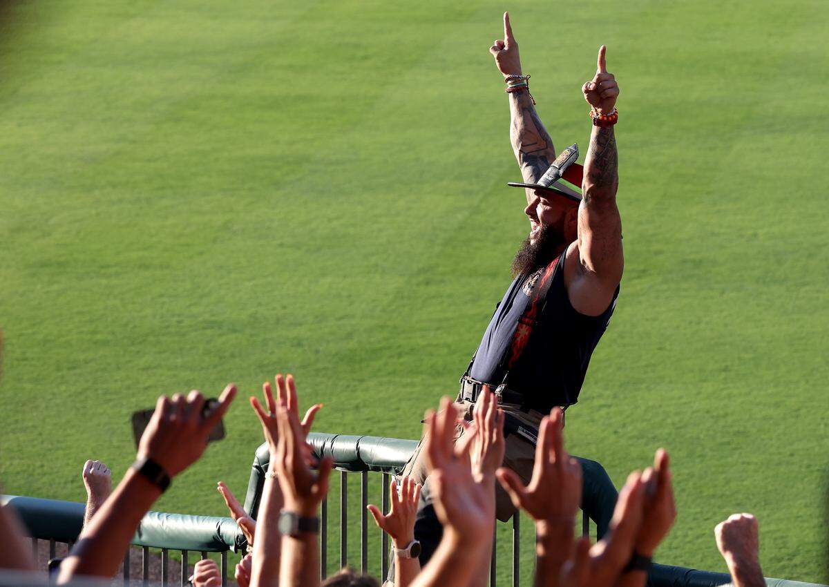 Mr. November celebrates the fans along the first base line and right field area winning a sing off against other fans during the Texas Tailgaters vs Firefighters at Truist Field in Charlotte, NC on Thursday, June 4, 2026. Banana Ball action returned to the Queen City with the Texas Tailgaters battling the Firefighters.