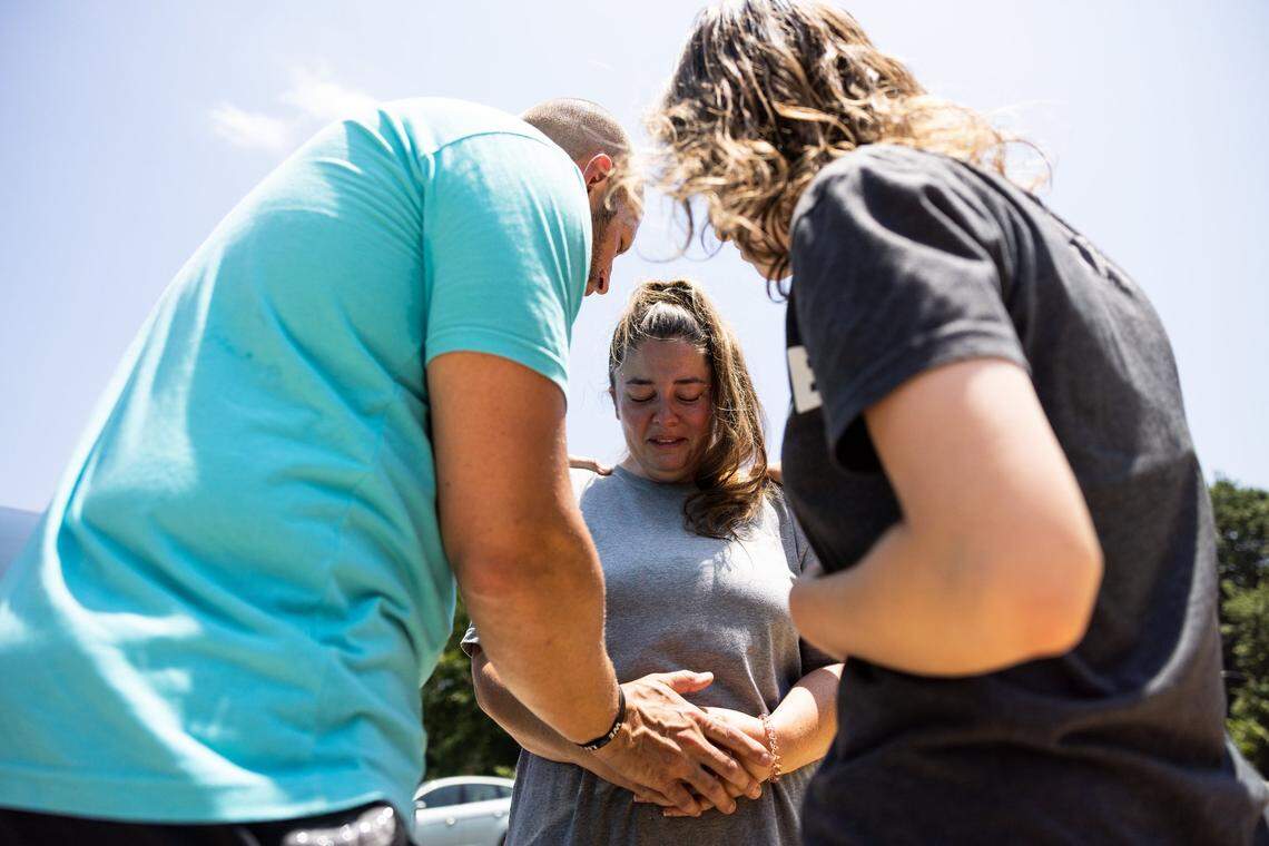 The anti-abortion group, Love Life, prays with a woman outside of A Preferred Women’s Health Center of Charlotte Friday in Charlotte after the Supreme Court overturned Roe vs Wade Friday morning