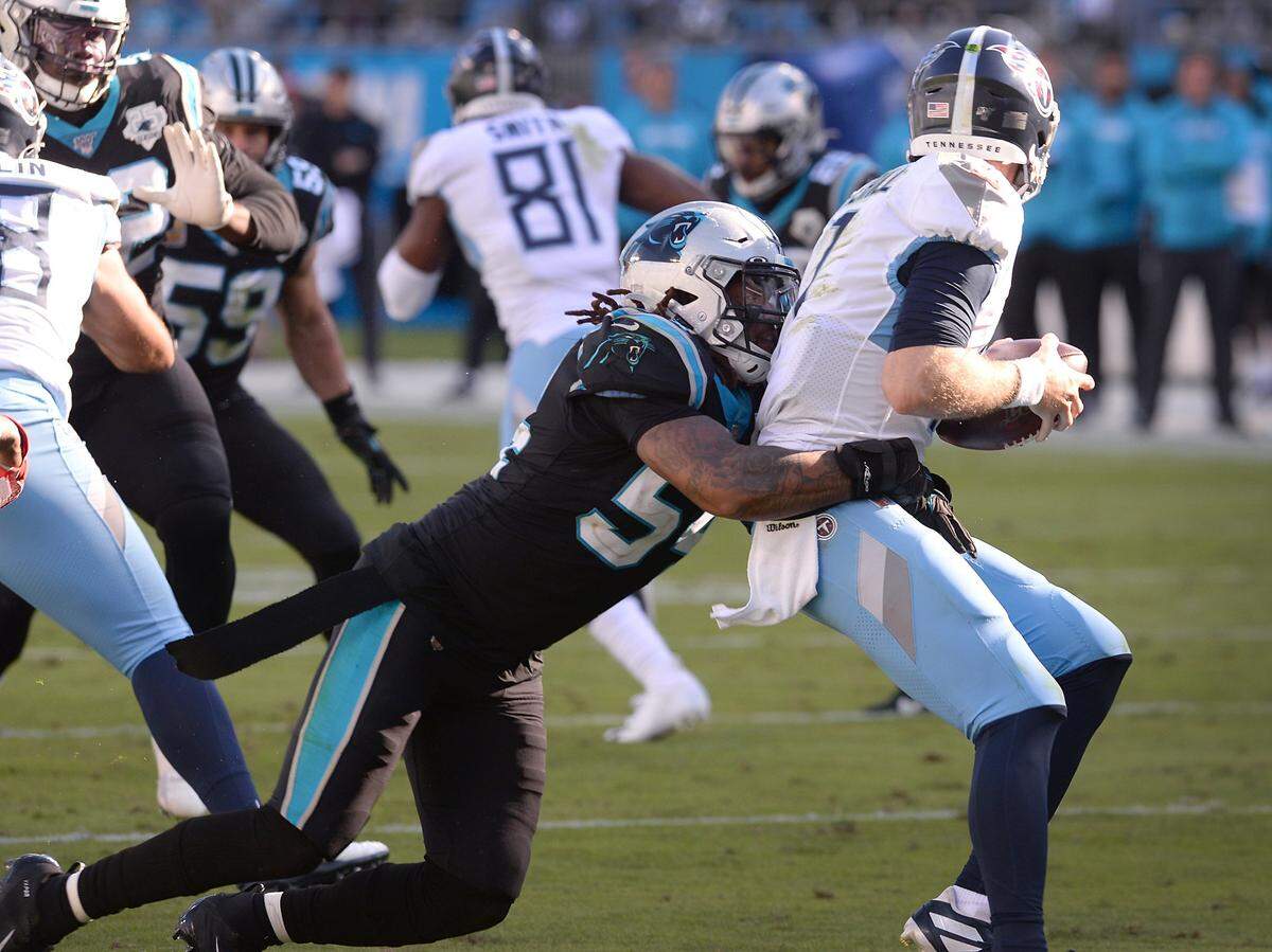 Carolina Panthers linebacker Shaq Thompson, left, sacks Tennessee quarterback Ryan Tannehill in 2019. The Panthers won that game, but Tannehill ultimately got Tennessee to the NFL’s “final four” and is about to become a free agent.