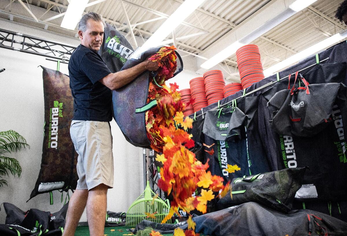 Marc Mataya demonstrates how to use a Leaf Burrito at the Leaf Burrito in Charlotte, NC, on Wednesday, September 29, 2021. The city earlier this year banned the use of plastic bags for yard waste, potentially making leaf removal more of a chore.