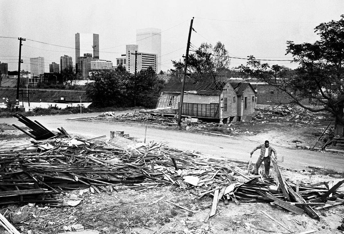 Urban renewal began in earnest in many southern cities in the 1960s. Don Sturkey captured a lone man salvaging lumber after the demolition of homes.