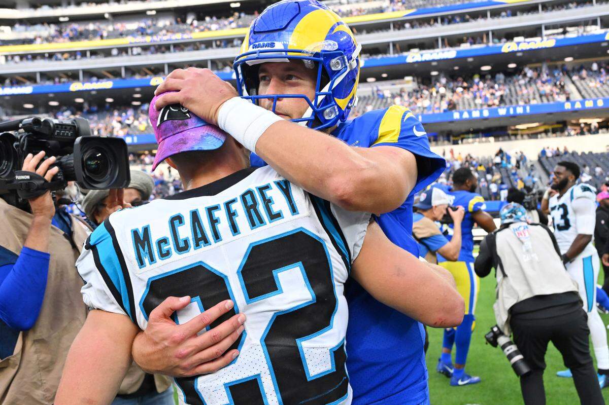 Los Angeles Rams quarterback Matthew Stafford, right, hugs Carolina Panthers running back Christian McCaffrey (22) after an NFL football game Sunday, Oct. 16, 2022, in Inglewood, Calif. (AP Photo/Jayne Kamin-Oncea)