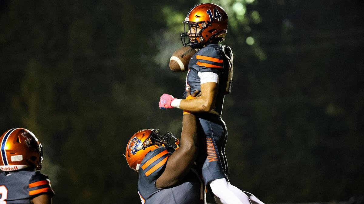 Chamber’s Jeremiah Blaylock (70) hoists teammate Jeremiah Harrison after scoring a touchdown against West Charlotte at Chambers High School on October 20, 2023.