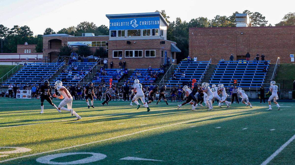 Charlotte Country Day, in white, must forfeit its semifinal football game Friday night because of a COVID-19 case.