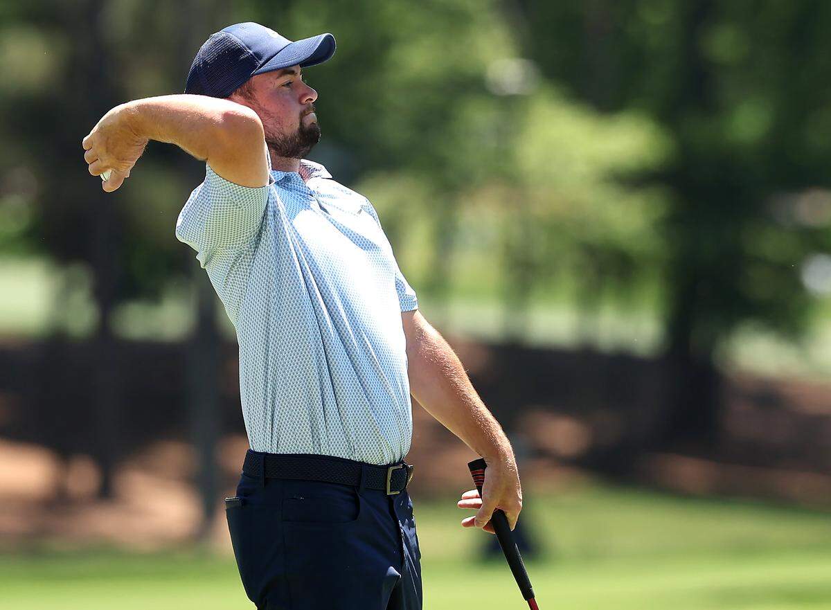 Alex Fitzpatrick tosses his ball to his caddie prior to putting on the second green during the final round of the Truist Championship at Quail Hollow Club in Charlotte, NC on Sunday, May 10, 2026.