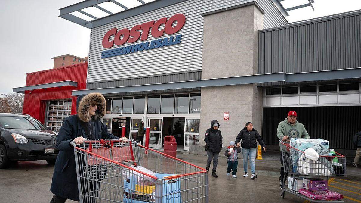 CHICAGO, ILLINOIS - DECEMBER 02: Customers walk in the parking lot outside a Costco store on December 02, 2025 in Chicago, Illinois. Costco is suing the Trump administration for a refund of tariffs the company alleges were improperly imposed by President Trump. The company contends that only Congress has the power to impose tariffs. (Photo by Scott Olson/Getty Images)
