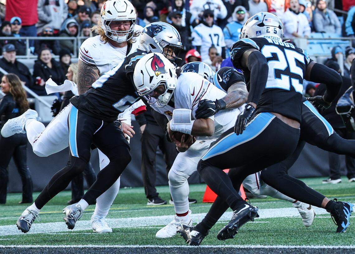 Cardinals quarterback Kyler Murray, center, drags Panthers defense as he runs into the end zone for a touchdown during a game on Dec. 22, 2024, at Bank of America Stadium.